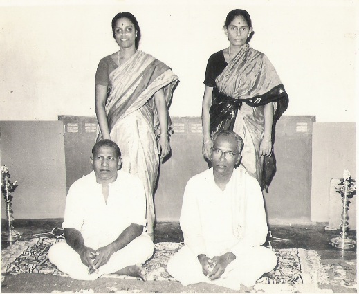 Left Gandhimathi Patti (standing), Srinu Thatha (sitting, her husband) Right Pankajavalli Patti (standing) Ramachandran Thatha (sitting, her husband). Celebration of Nithya’s mother’s wedding. 1973. Left Gandhimathi Patti (standing), Srinu Thatha (sitting, her husband) Right Pankajavalli Patti (standing) Ramachandran Thatha (sitting, her husband). Celebration of Nithya’s mother’s wedding. 1973.