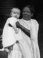 Stanley, 5 months old, held high in the arms, close to the loving face of my first ayah, Marrimma, a Telugu speaking family servant. Stanely with Ayah